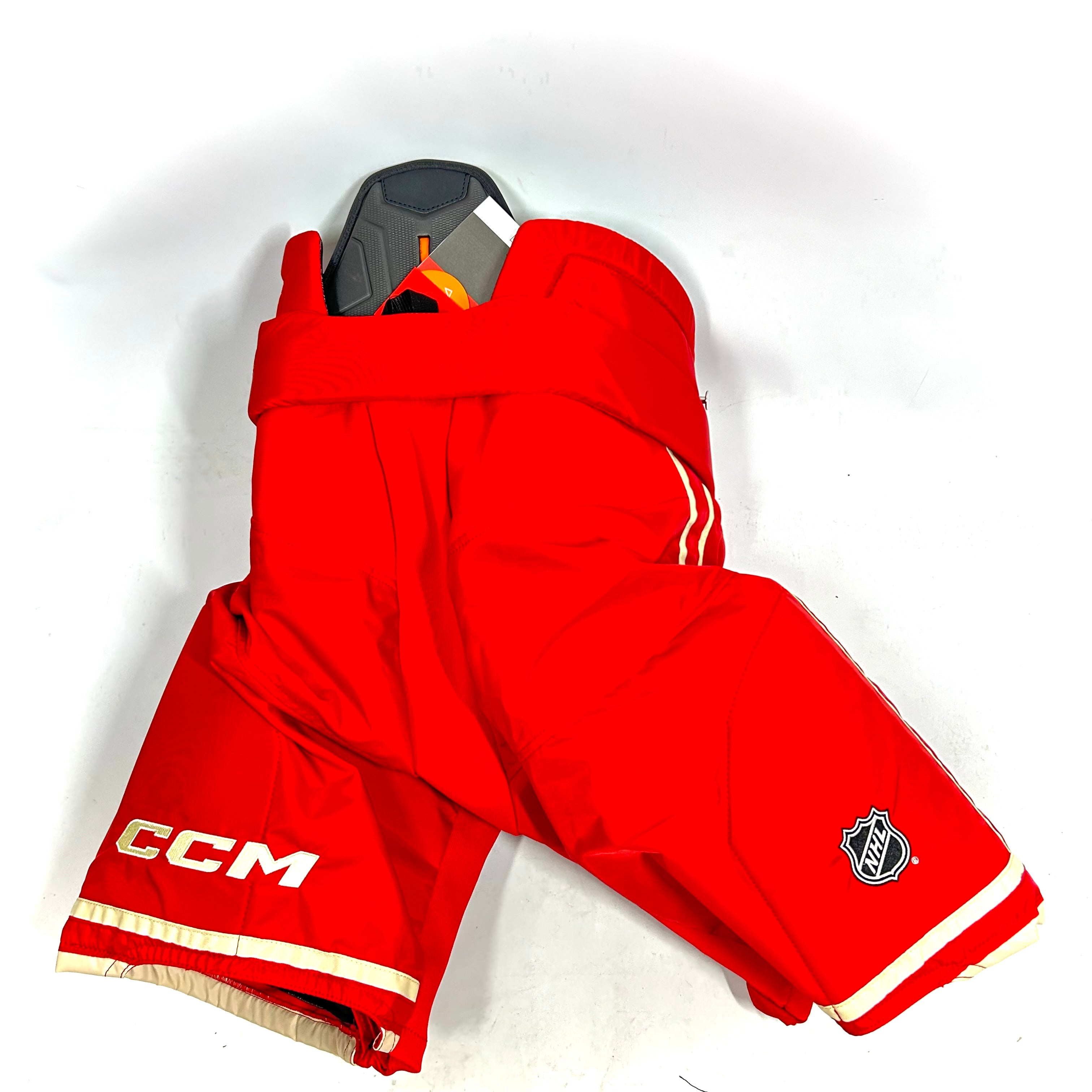 CCM HPTK - Pantalon de hockey professionnel NHL - Flames de Calgary (rouge/blanc)